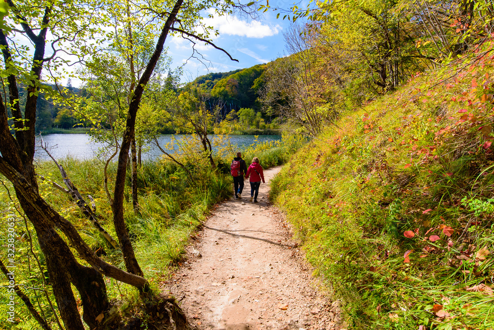 Obraz premium People walking on the trekking path at Plitvice Lakes National Park (Plitvička Jezera), a national park in Croatia