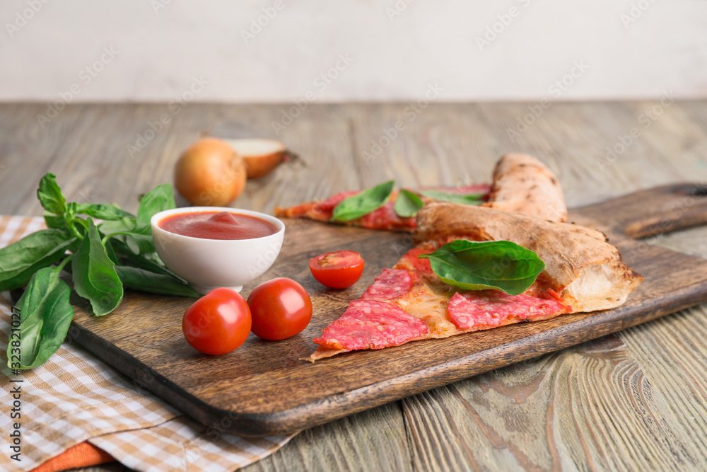 Slices of tasty pizza on wooden table Slices of tasty pizza on wooden table