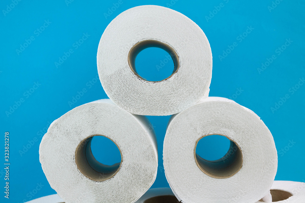 Toilet paper on blue bathroom background Toilet paper on blue bathroom background
