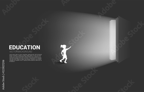 Silhouette of running girl point to light from open book. Concept of education solution. world of knowledge.