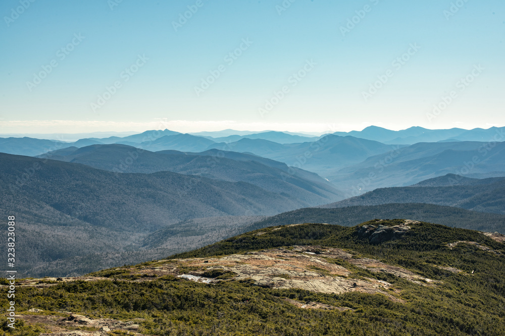 Coniferous forest covered mountain ridge with a hiking trail on top. White Mountains, New Hampshire