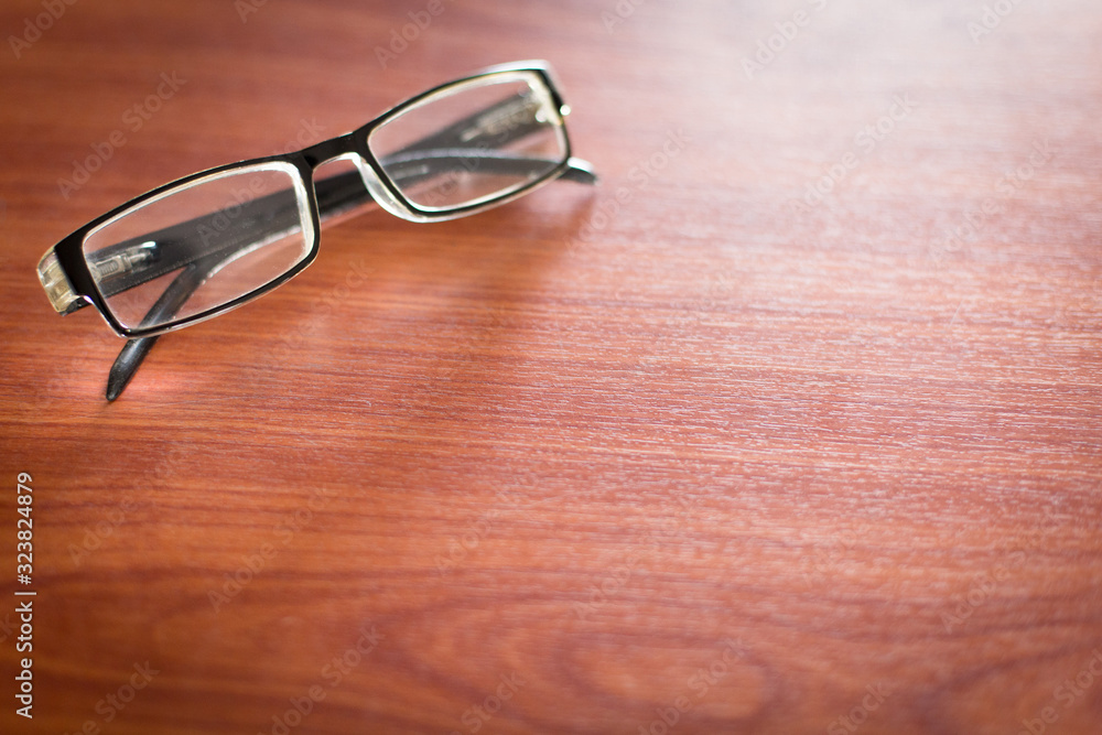 Selective focus of eye Glasses on the desk with sunlight Selective focus of eye Glasses on the desk with sunlight