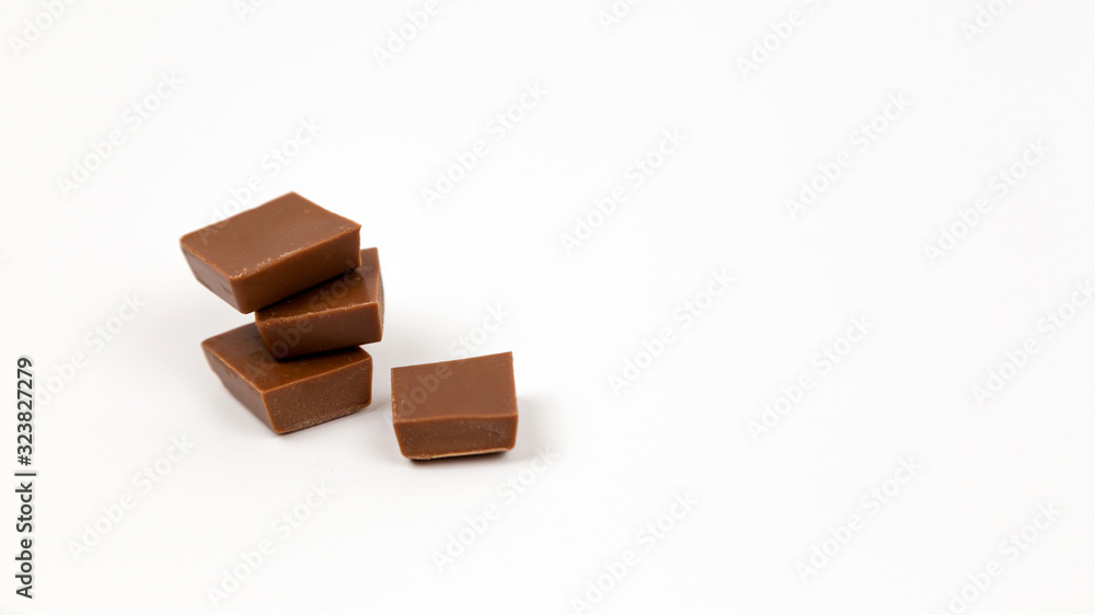 Macro photo of Chocolate bar. Broken pieces over white background Macro photo of Chocolate bar. Broken pieces over white background
