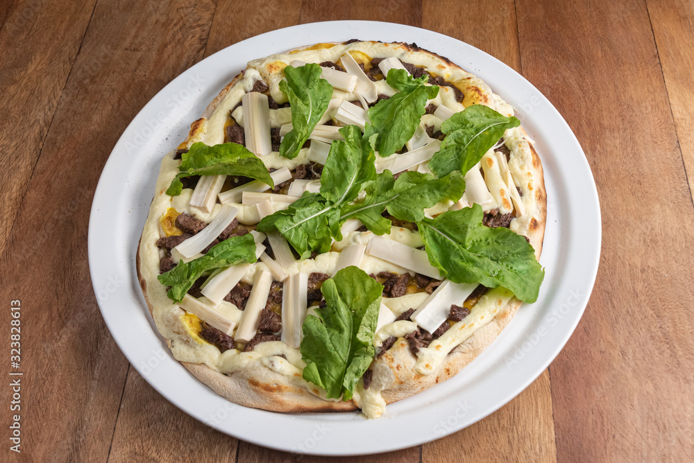 Pizza on the brown wooden table Pizza on the brown wooden table