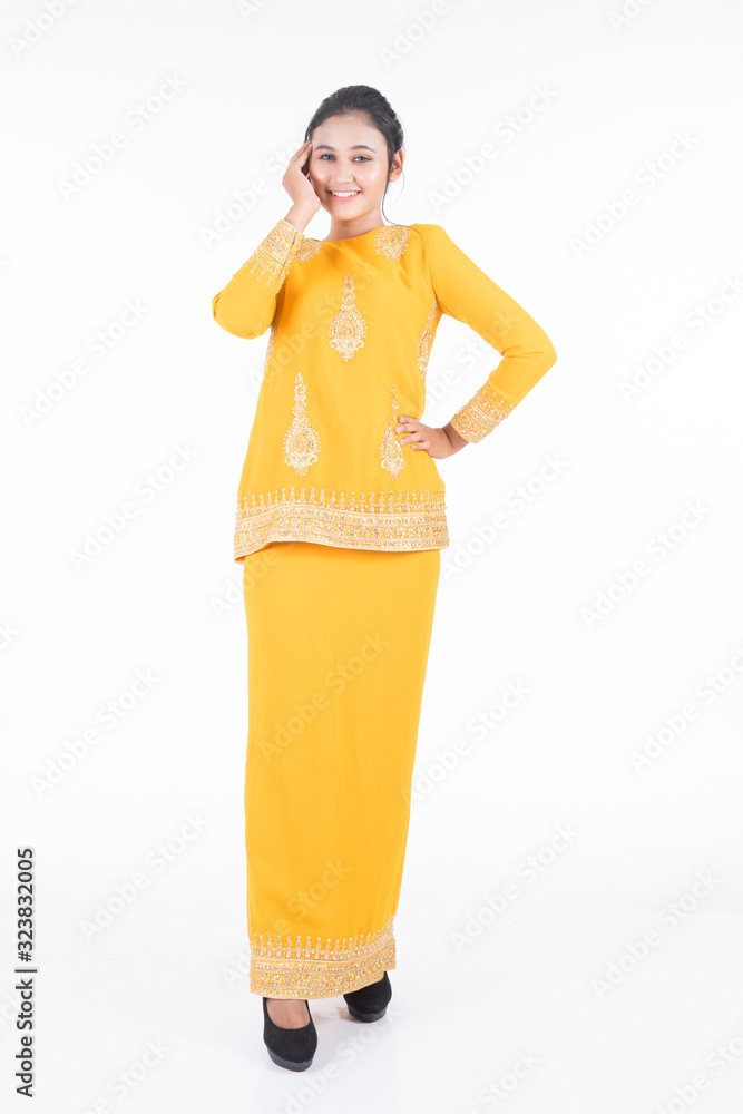 Beautiful female Asian model in various poses wearing modern kurung, a Malaysian traditional wear isolated on white background. Beauty and fashion concept. Full length portrait Beautiful female Asian model in various poses wearing modern kurung, a Malaysian traditional wear isolated on white background. Beauty and fashion concept. Full length portrait