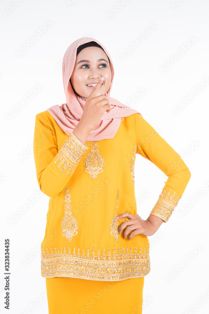 Beautiful female Muslim model in modern kurung and hijab, a modern