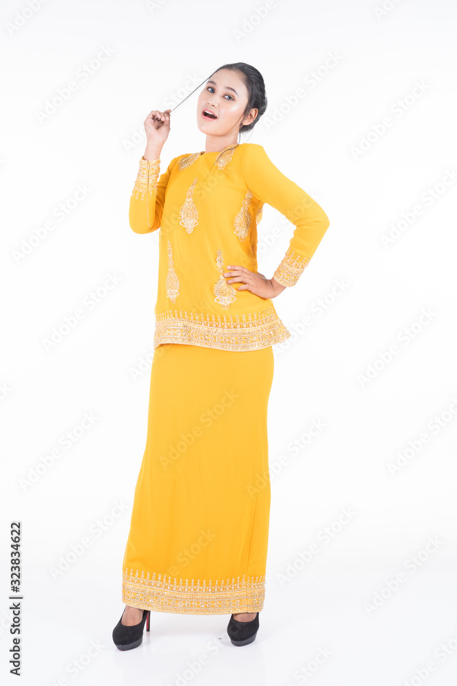 Beautiful female Asian model in various poses wearing modern kurung, a Malaysian traditional wear isolated on white background. Beauty and fashion concept. Full length portrait Beautiful female Asian model in various poses wearing modern kurung, a Malaysian traditional wear isolated on white background. Beauty and fashion concept. Full length portrait