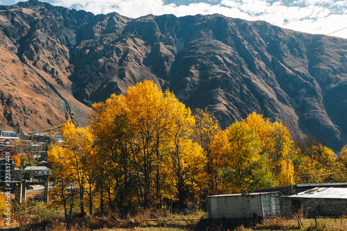 Stepantsminda, Kazbegi, Goergia. Cityscape of big rural town with mountain range of Kazbak. photo