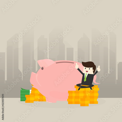 Young Business man sit money coin and show .Thumbs up with piggy bank,saving concept.