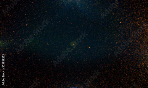 Abstract retro 1920 style vintage background of flickering gold tone particles and light flare