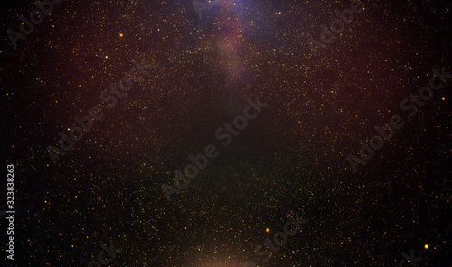 Abstract retro 1920 style vintage background of flickering gold tone particles and light flare
