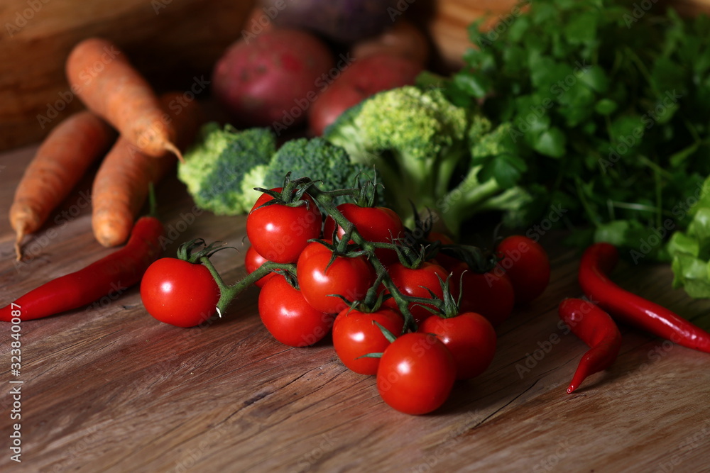 fresh vegetables for cooking on a structural wooden table fresh vegetables for cooking on a structural wooden table