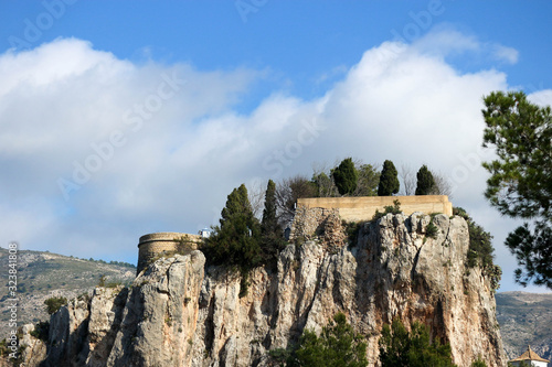 Panoramic view to the ruins of an old San Jose castle in Castell de Guadalest under the clouds photo