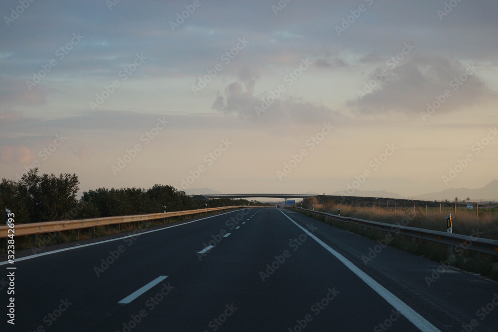 Fototapeta premium driving on highway into the sunset