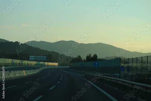 highway in the mountains at the sunset