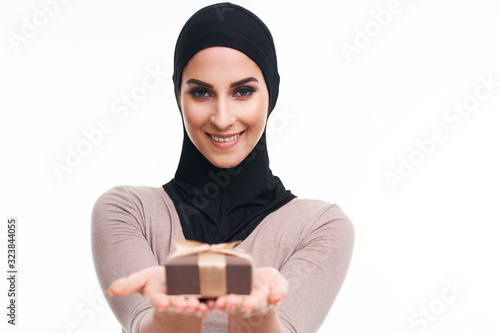 Muslim woman with present over white background