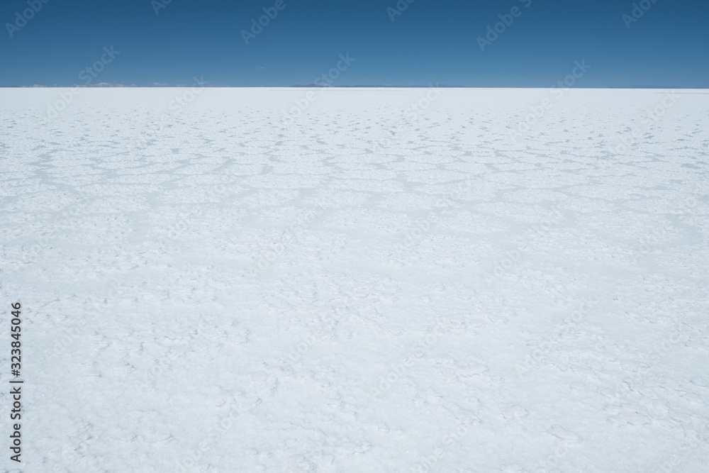 Flat and white surface of the Salar de Uyuni salt flat, Bolivia