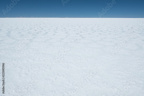 Flat and white surface of the Salar de Uyuni salt flat, Bolivia