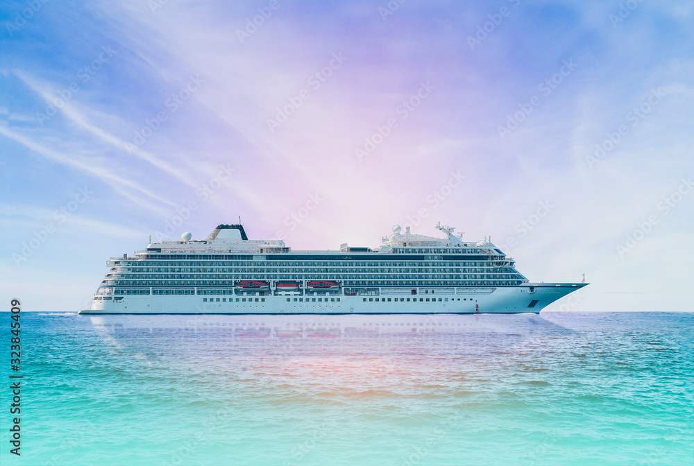 Cruise ship, large luxury white cruise ship liner on blue sea water and cloudy sky background.