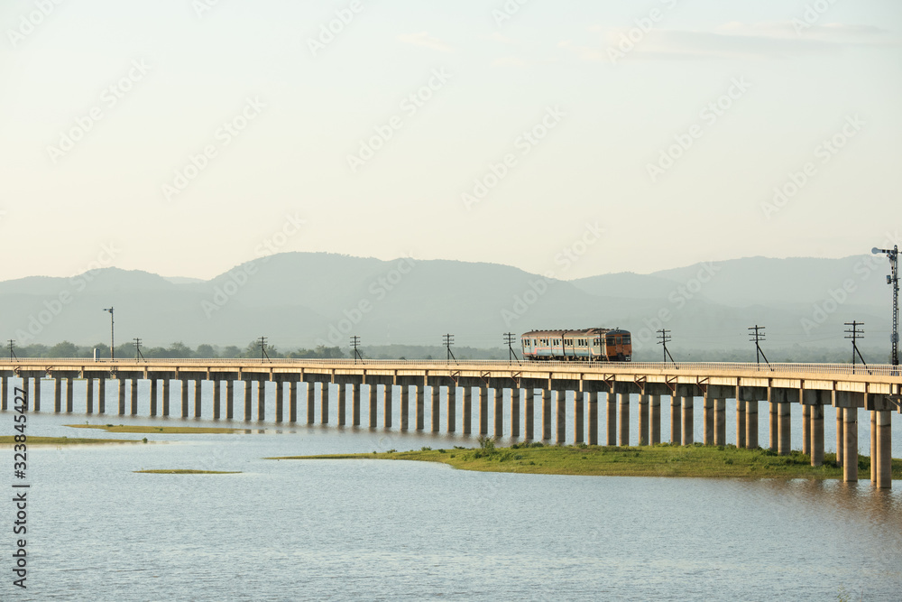 Landscape View of  Train crossing Pasak Chonlasit Dam. Reservoir for agriculture at Lopburi,Thailand