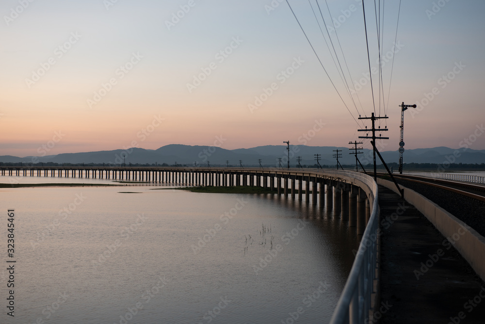 Landscape View of  Train crossing Pasak Chonlasit Dam. Reservoir for agriculture at Lopburi,Thailand