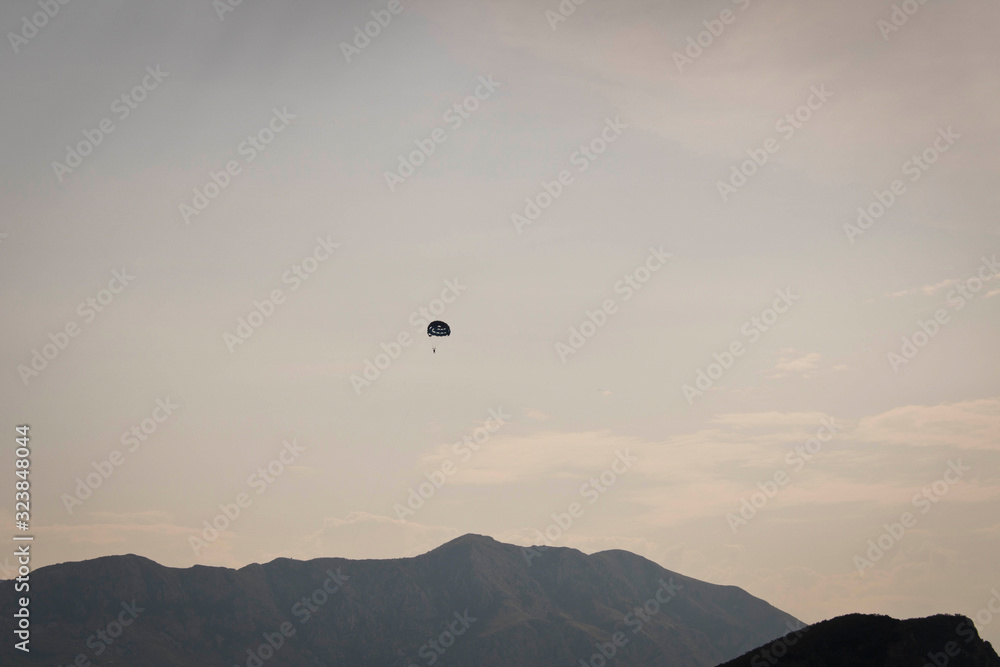 Skydiver flying far in the sky over the mountains. Skydiver flying far in the sky over the mountains.