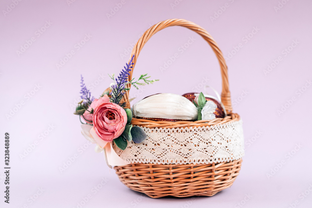 Easter. Basket with eggs on a pastel pink background