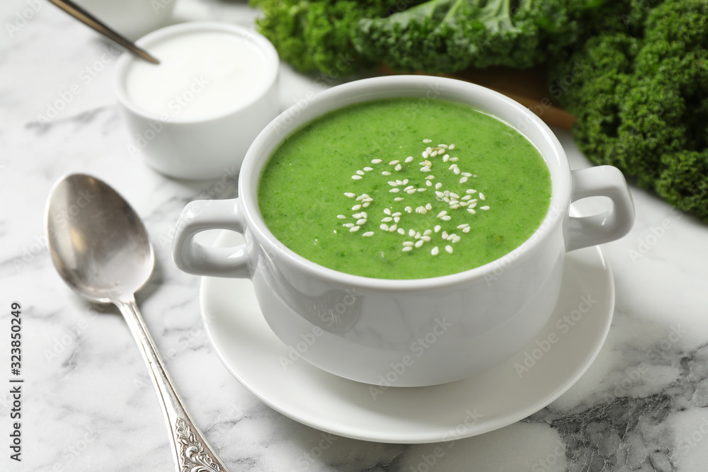 Tasty kale soup with sesame seeds on white marble table, closeup Tasty kale soup with sesame seeds on white marble table, closeup
