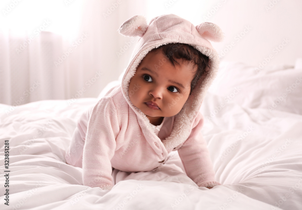Cute African American baby on bed at home Cute African American baby on bed at home