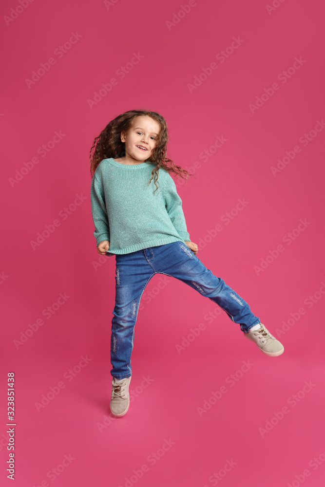 Cute little girl jumping on pink background Cute little girl jumping on pink background