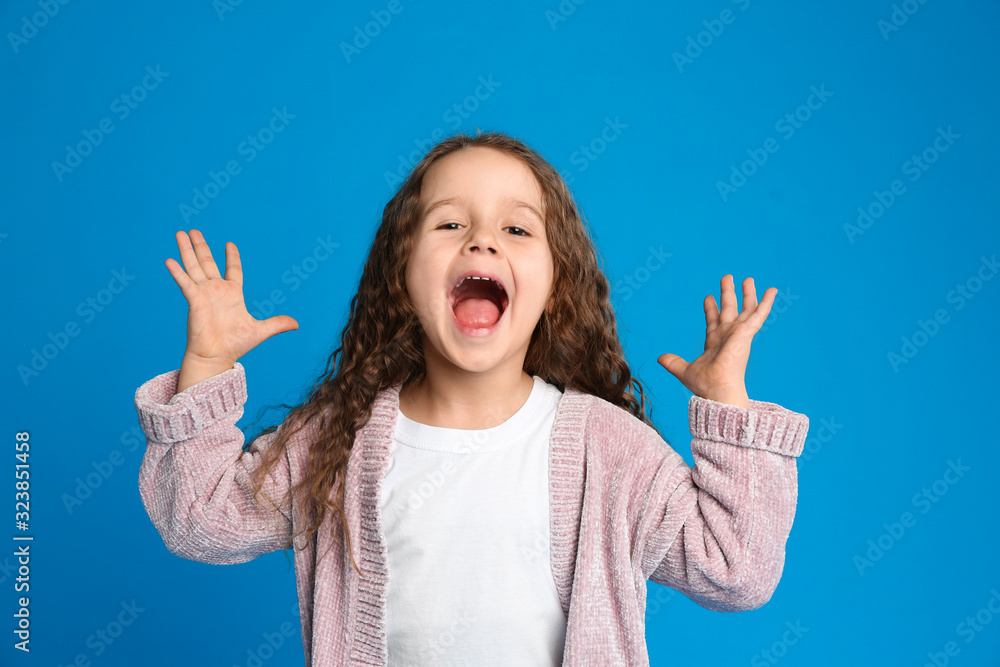 Portrait of cute little girl on light blue background Portrait of cute little girl on light blue background