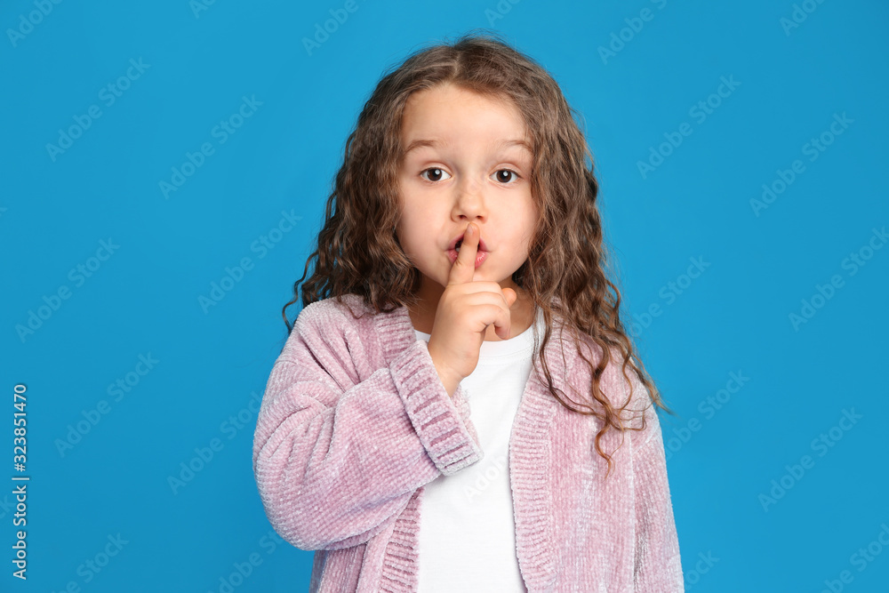 Portrait of cute little girl on light blue background Portrait of cute little girl on light blue background