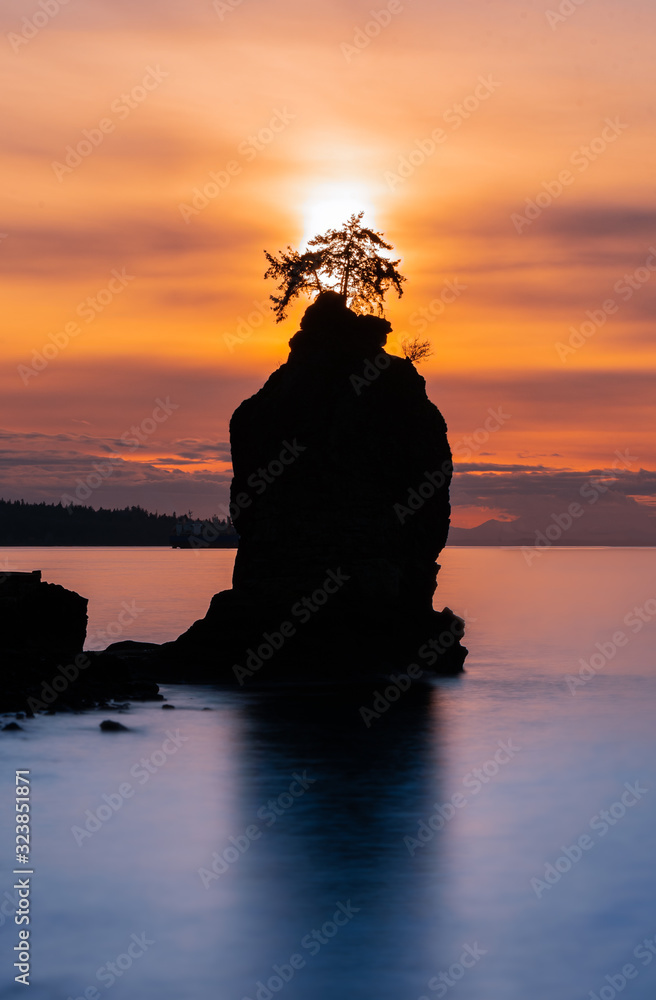 Sunset behind Siwash Rock on Vancouver's seawall around Stanley Park