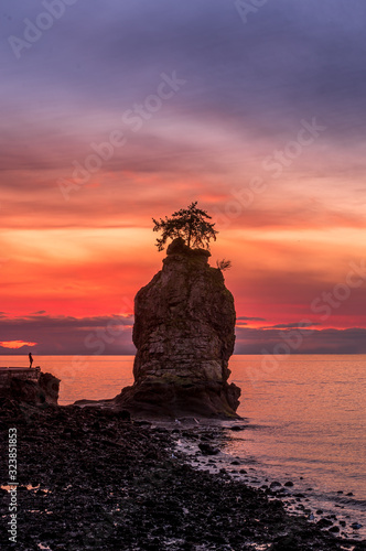 Sunset behind Siwash Rock on Vancouver's seawall around Stanley Park photo