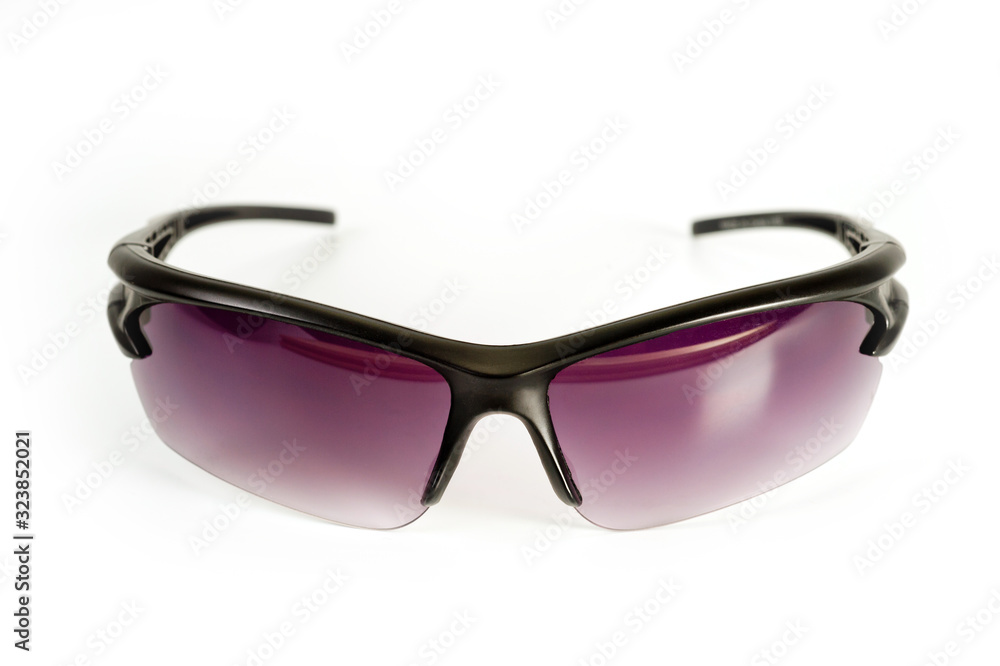 Sports and safety glasses made of black plastic with dark glasses, shot on a white background. Background for cycling. Background for work safety. Sports and safety glasses made of black plastic with dark glasses, shot on a white background. Background for cycling. Background for work safety.
