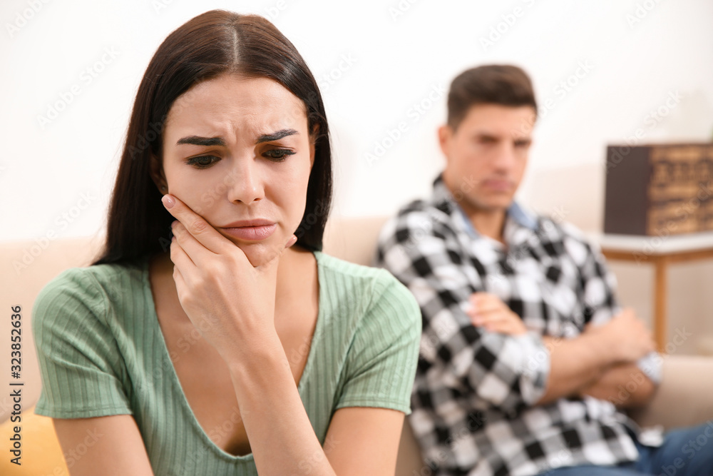 Unhappy woman after quarrel with her boyfriend at home. Relationship problems