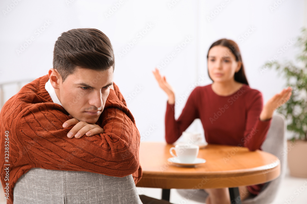 Unhappy man after quarrel with his girlfriend indoors. Relationship problems Unhappy man after quarrel with his girlfriend indoors. Relationship problems