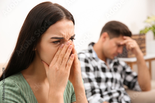 Woman crying after quarrel with her boyfriend at home. Relationship problems