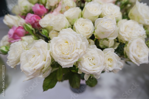 White roses, beautiful bouquet in the flower-shop. Running florists business.