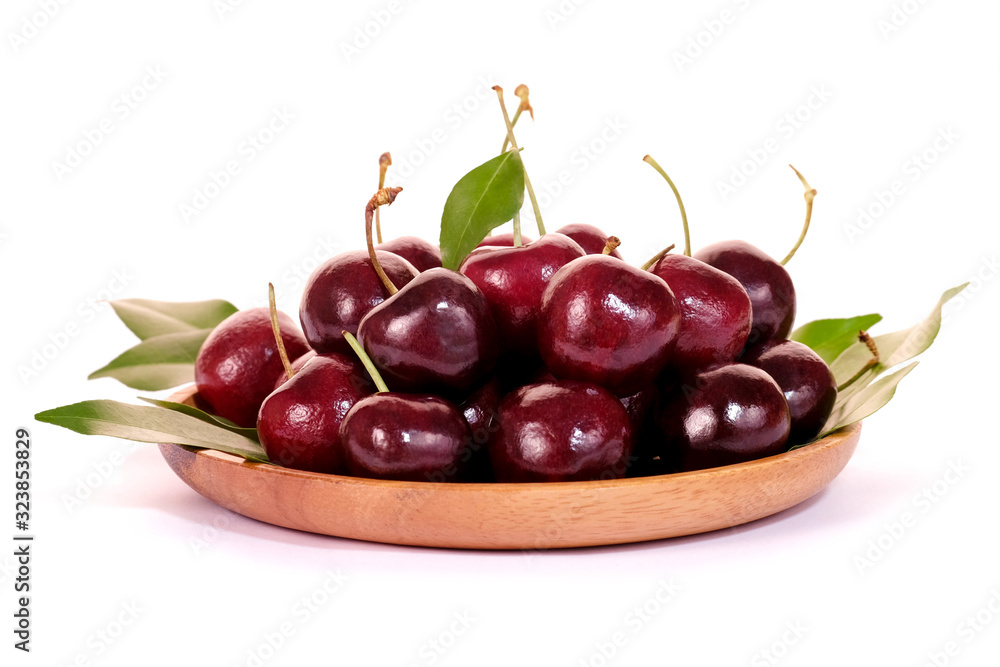 Texture of cherry in wooden plate isolated on white background. Sweet fresh cherry. Texture of cherry in wooden plate isolated on white background. Sweet fresh cherry.