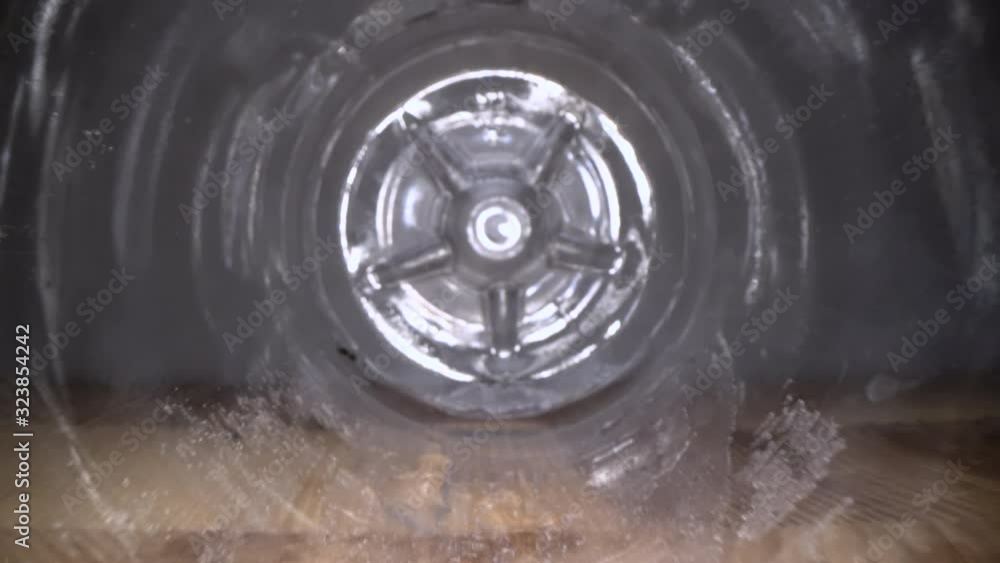 Inside the plastic bottle. Dolly macro shot of camera zooming in empty water bottle on wooden background Inside the plastic bottle. Dolly macro shot of camera zooming in empty water bottle on wooden background