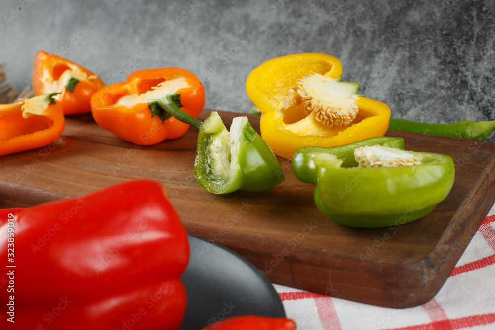 Mixed color bell peppers on a wooden board. Mixed color bell peppers on a wooden board.