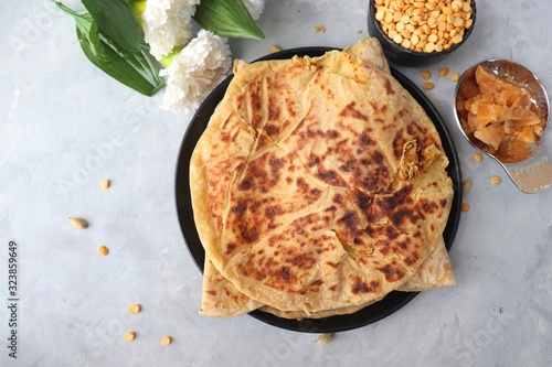  Holi Festival Food - Puran Poli is an Indian sweet flatbread stuffed with mixture of chana dal, jaggery, ghee & cardamom. Usually eaten on Holi or Gudi Padva festival. Recipe ingredients. copy space. photo