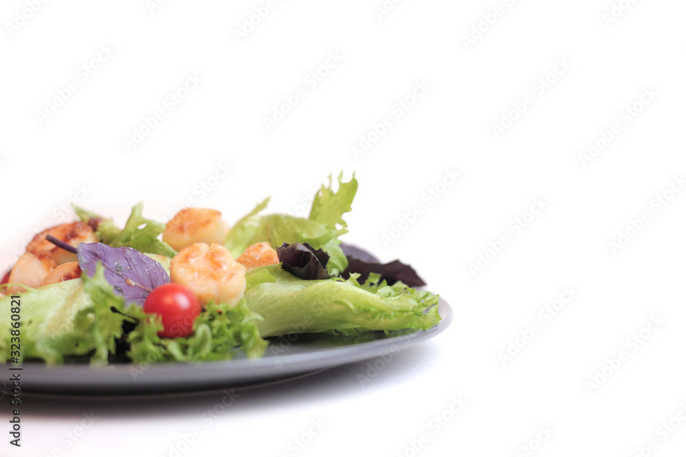 Seafoods - Shrimps, Sea Scallops, Squids and Salmon. Garnished with Fresh Raw Salad Leaf. Seafoods - Shrimps, Sea Scallops, Squids and Salmon. Garnished with Fresh Raw Salad Leaf.