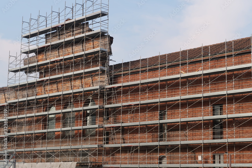Construction site with scaffolding on the facade of a historic building of the University of Milan.