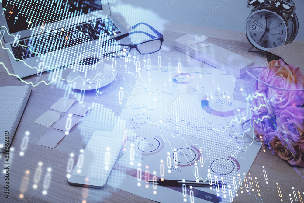 Forex market graph hologram and personal computer on background. Multi exposure. Concept of investment. Forex market graph hologram and personal computer on background. Multi exposure. Concept of investment.