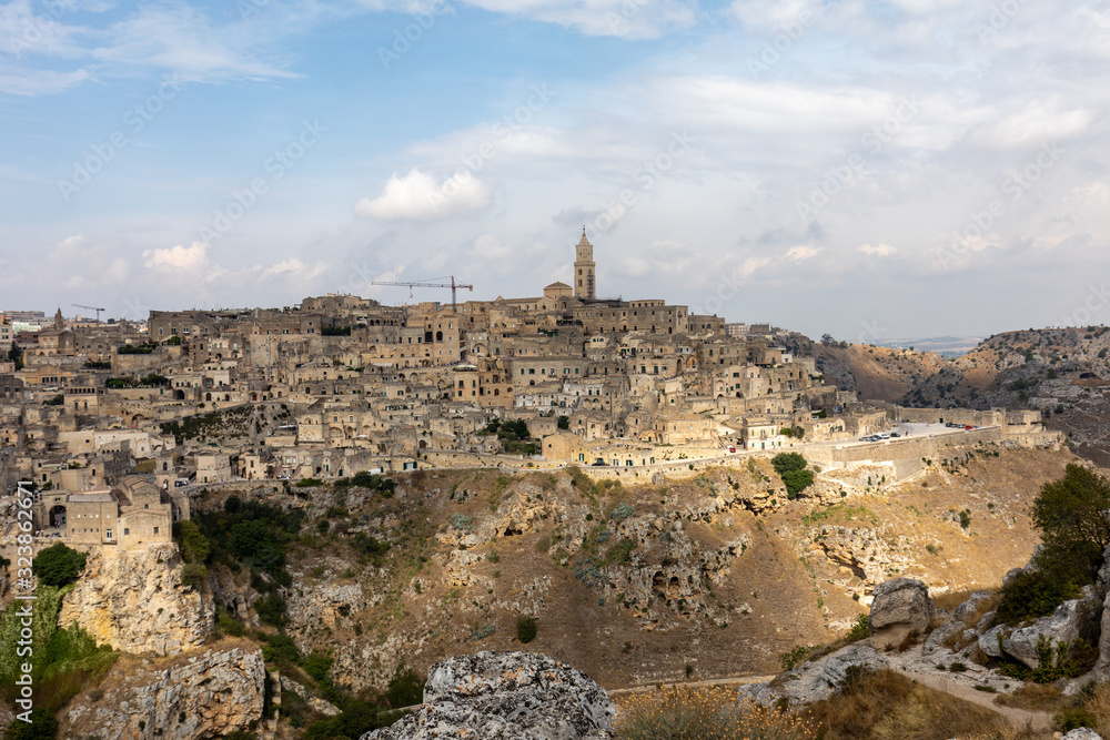 Panoramic view of Sassi di Matera a historic district in the city of Matera, well-known for their ancient cave dwellings from the Belvedere di Murgia Timone,  Basilicata, Italy