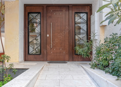 Elegant apartments building wood and glass door, Athens Greece © Dimitrios