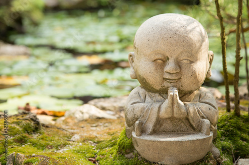 Photograph of a small buddha statue praying 