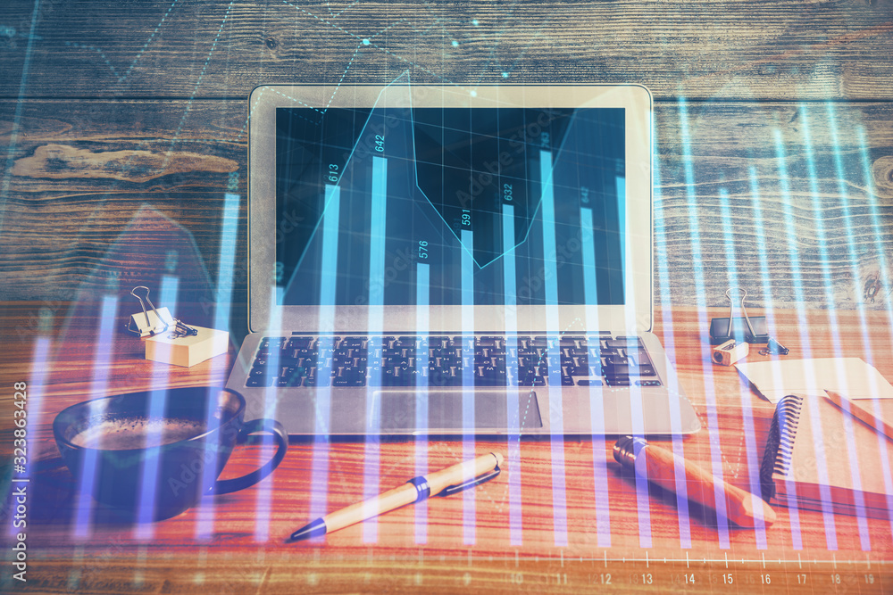 Multi exposure of chart and financial info and work space with computer background. Concept of international online trading. Multi exposure of chart and financial info and work space with computer background. Concept of international online trading.